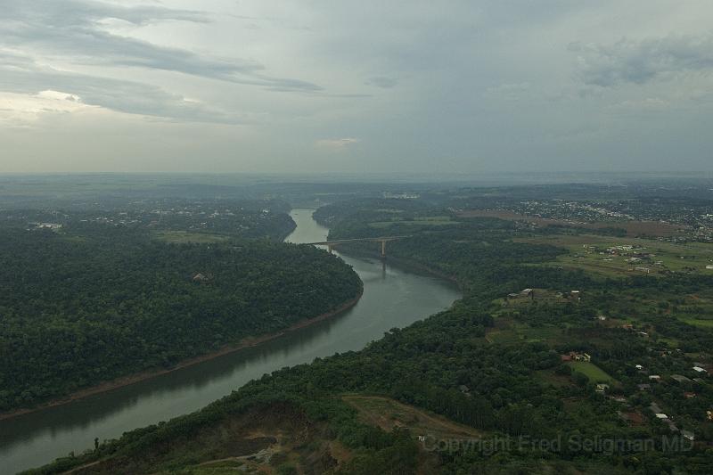 20071204_162525  D2X 4200x2800.jpg - Approaching the Fraternity Bridge which crosses the Pirana River joining Foz Do Iguacu, Brazil (on right) with Puerto Iguazu, Argentina (distant left).  Commerce across this border is not as great as across the Friendship Bridge